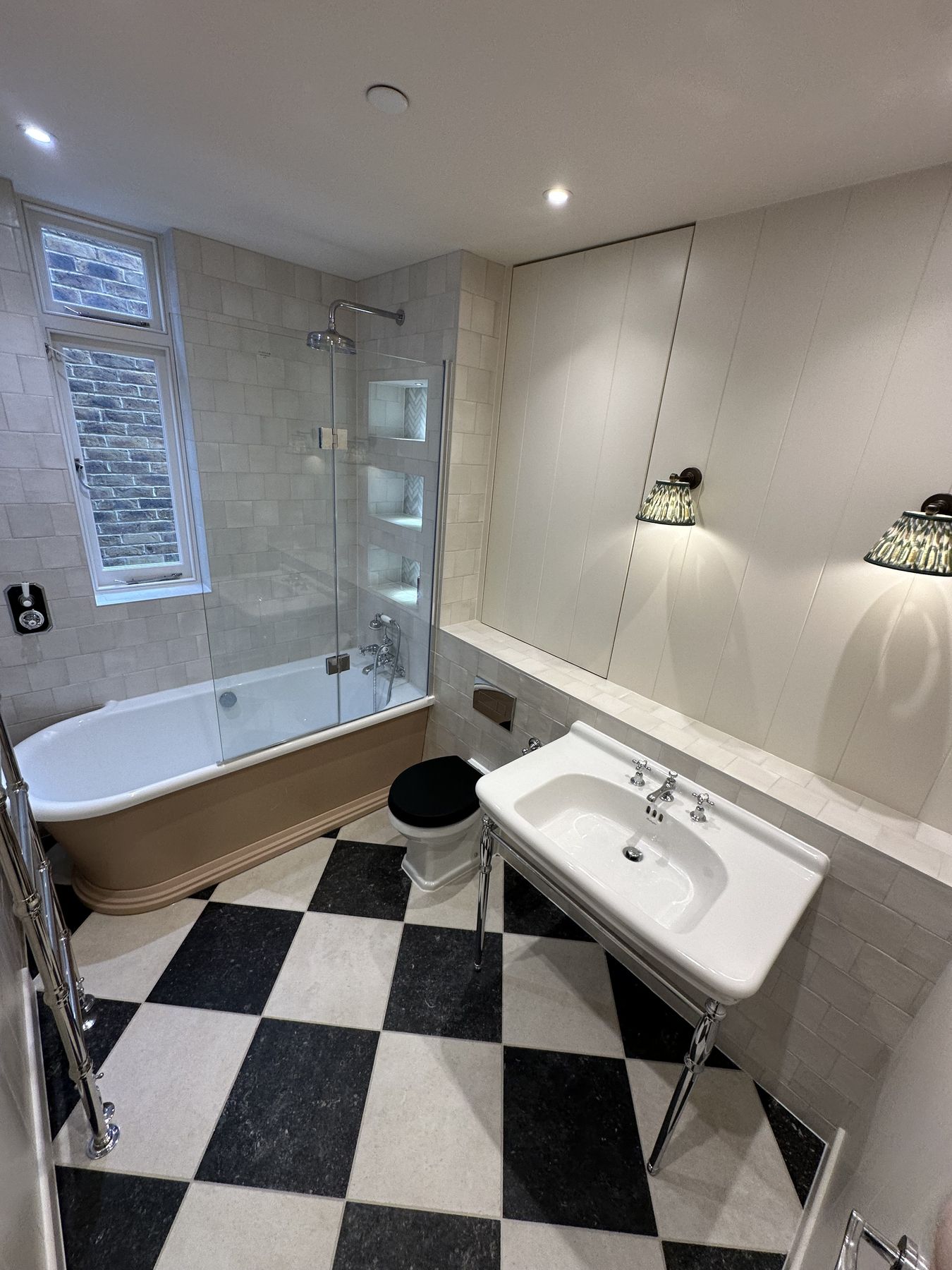 Bath beneath the window and a chrome washstand