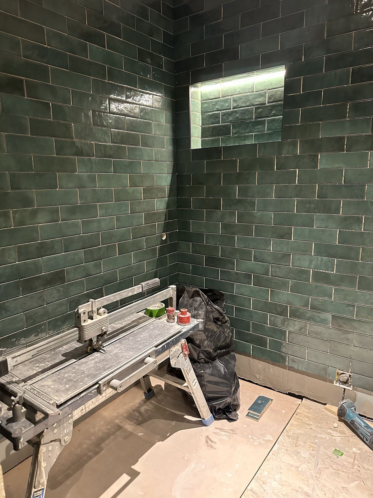 Green tiling in progress — Deep Green, Warm Walnut — Shower Room, Twickenham