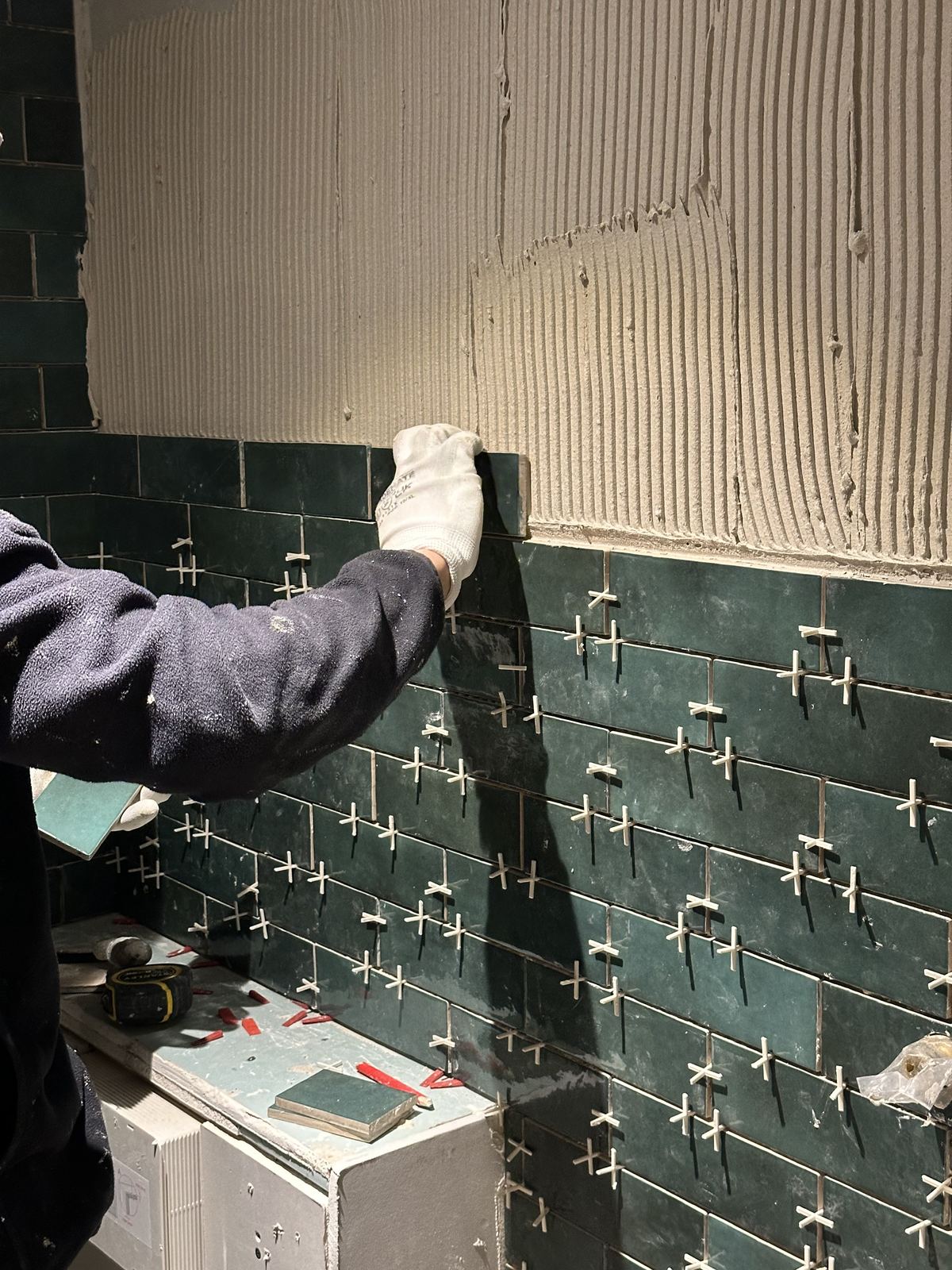 Laying the metro tiles — Deep Green, Warm Walnut — Shower Room, Twickenham