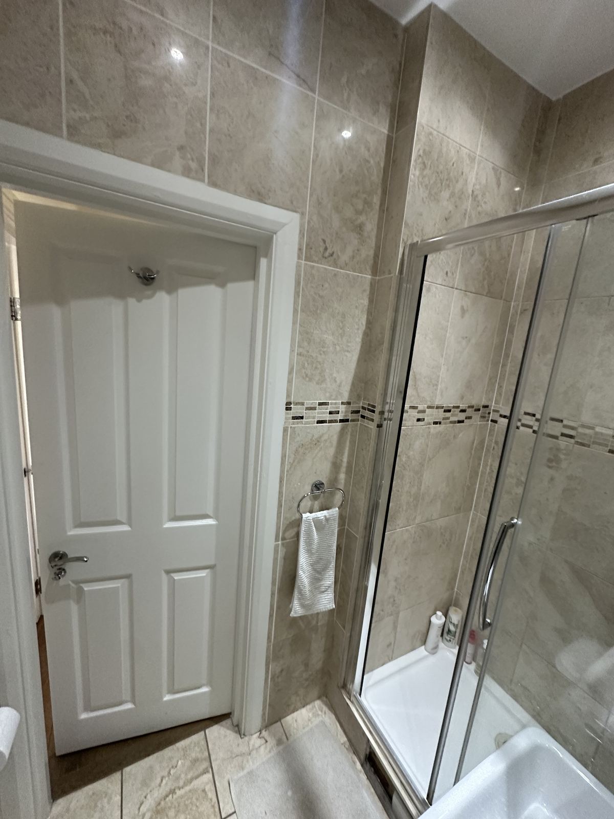 Beige tiling — Framed in Black — Shower Room, Fulham
